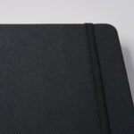 Load image into Gallery viewer, 150gsm A5 dot grid notebook black paper saffiano texture cover
