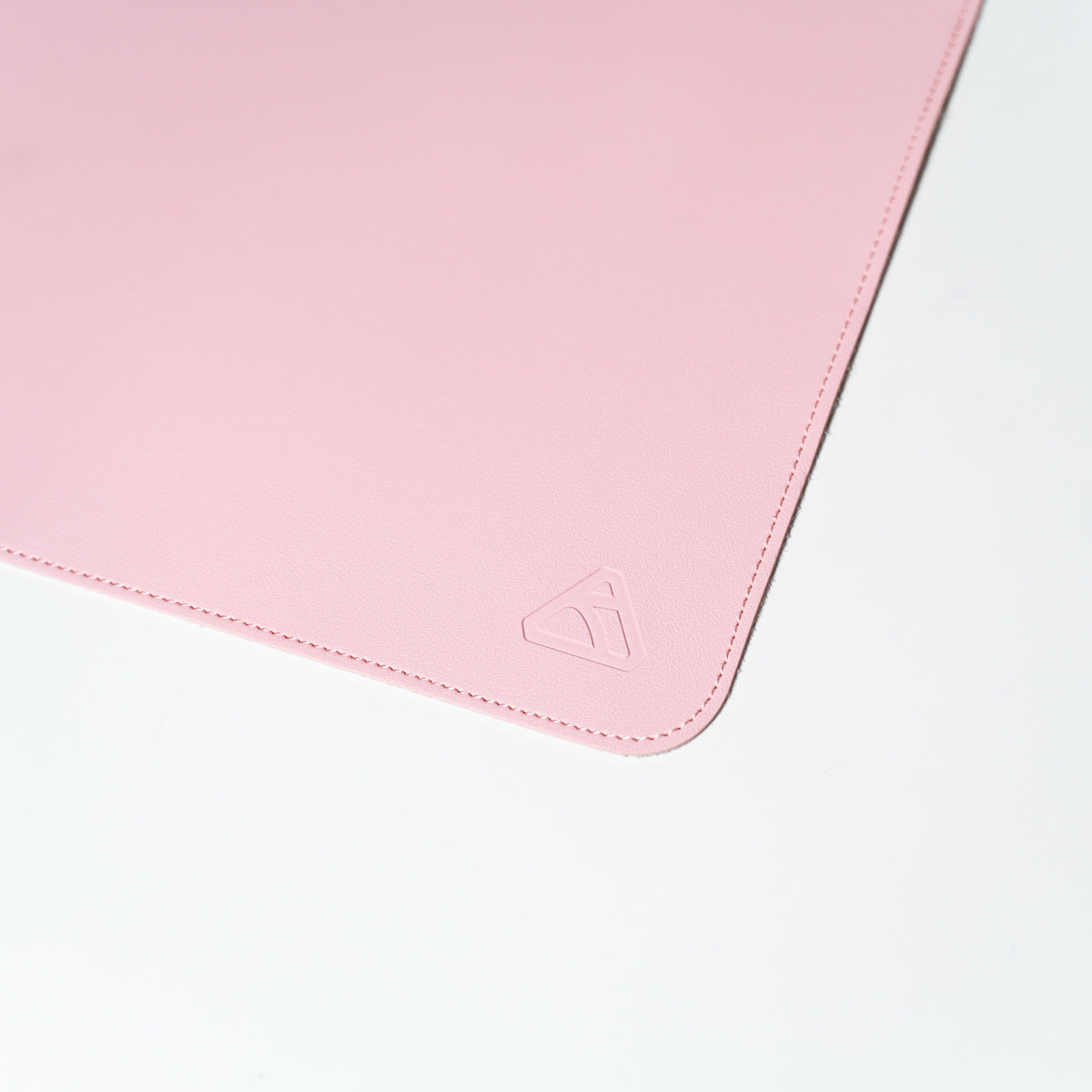 Pink leather desk mat with Ryskape logo